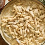 cottage cheese alfredo pasta with chicken in a skillet ready to serve
