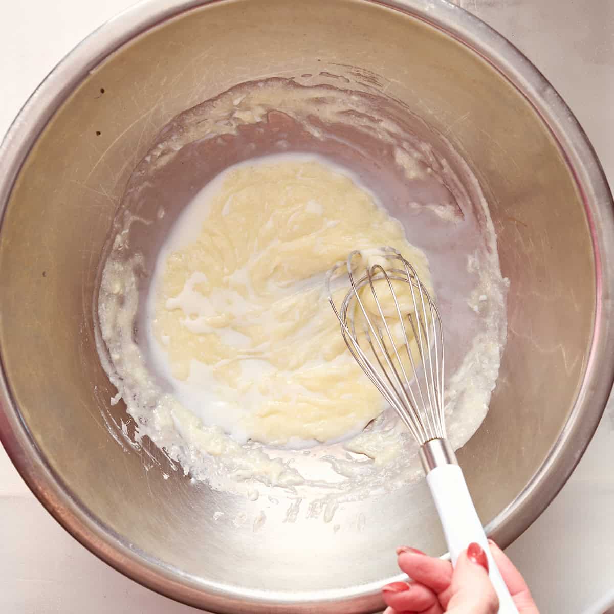 adding cold milk to the butter