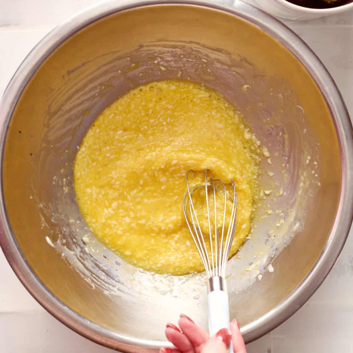 whisking the wet ingredients together in a mixin bowl