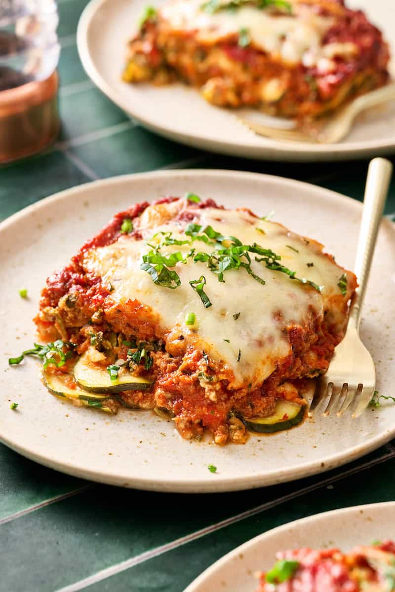 a serving of zucchini lasagna on a plate with a fork