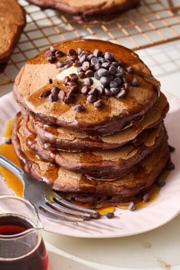 chocolate sourdough pancake stack with maple syrup and chocolate chips